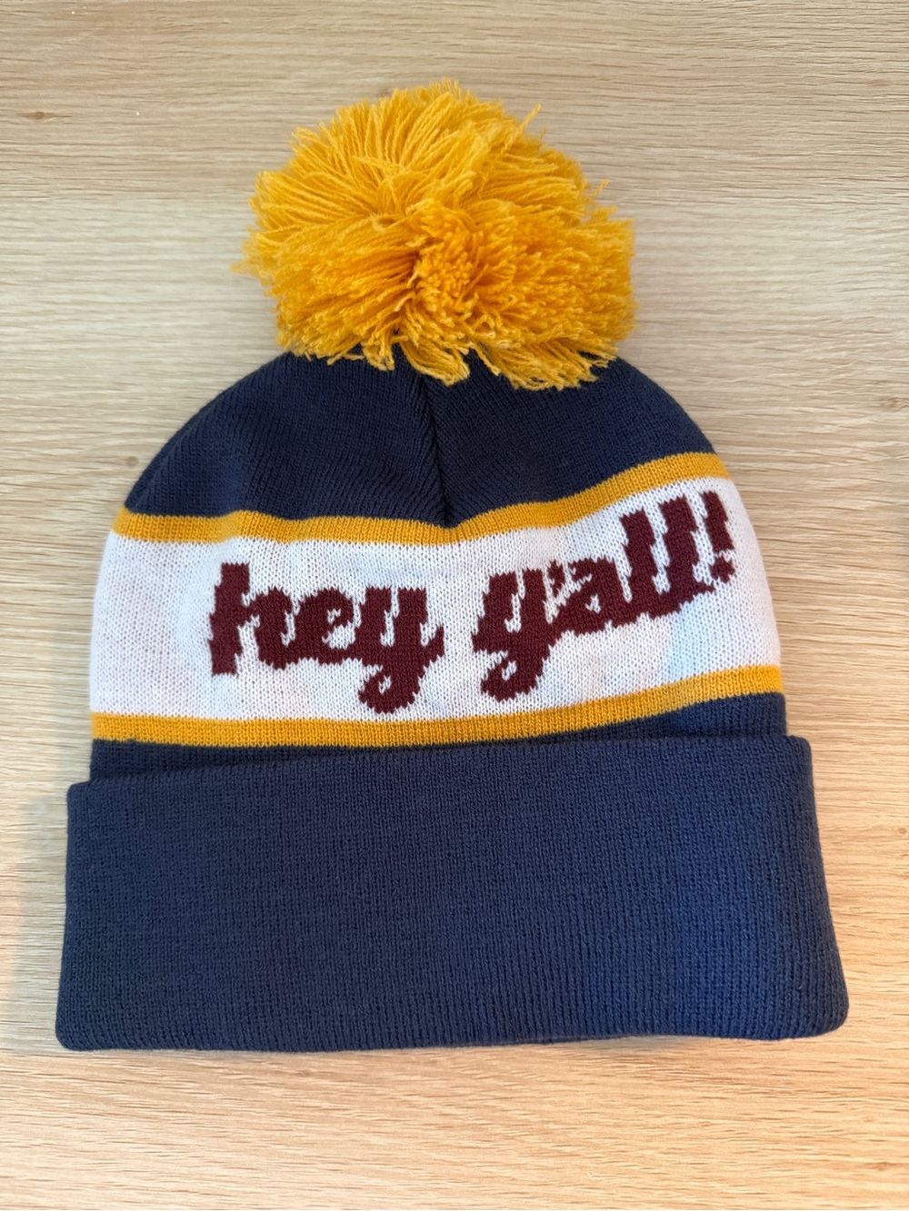 Navy Pom Beanie with Yellow Pom and 'hey y'all' Script